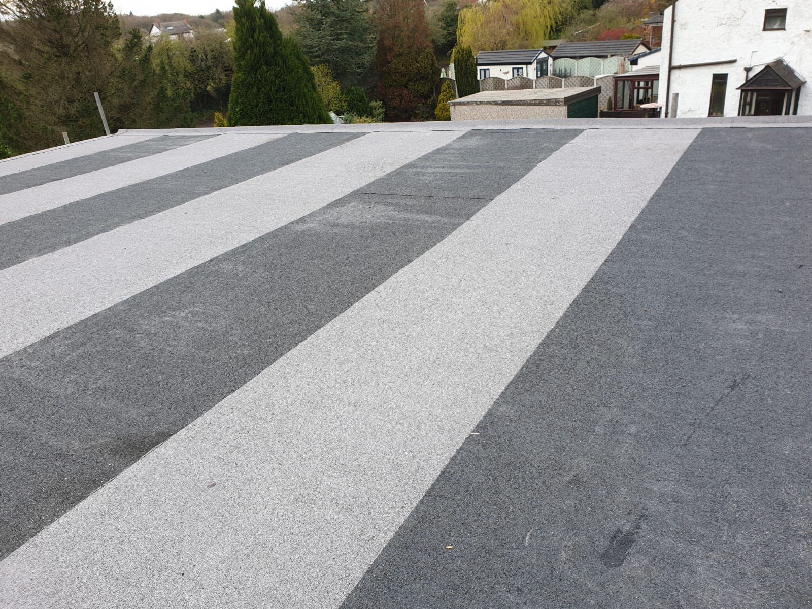 Completed flat roof with contrasting roof surface strips